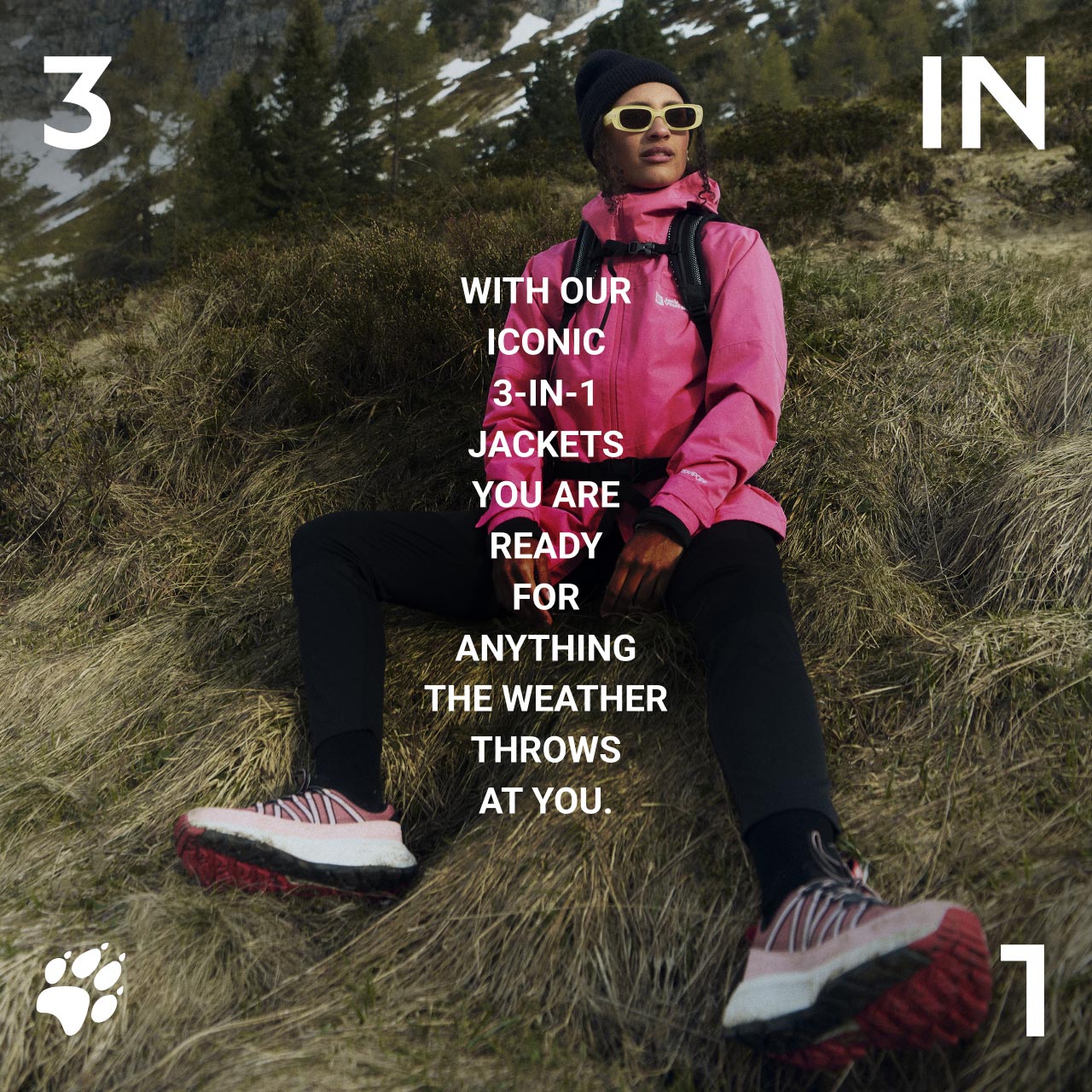 Une personne en rose avec veste et bonnet, assise sur une pente recouverte d’herbe avec lunettes de soleil et chaussures de randonnée. Texte : « With our iconic 3-in-1 jackets, you are ready for anything the weather throws at you. »